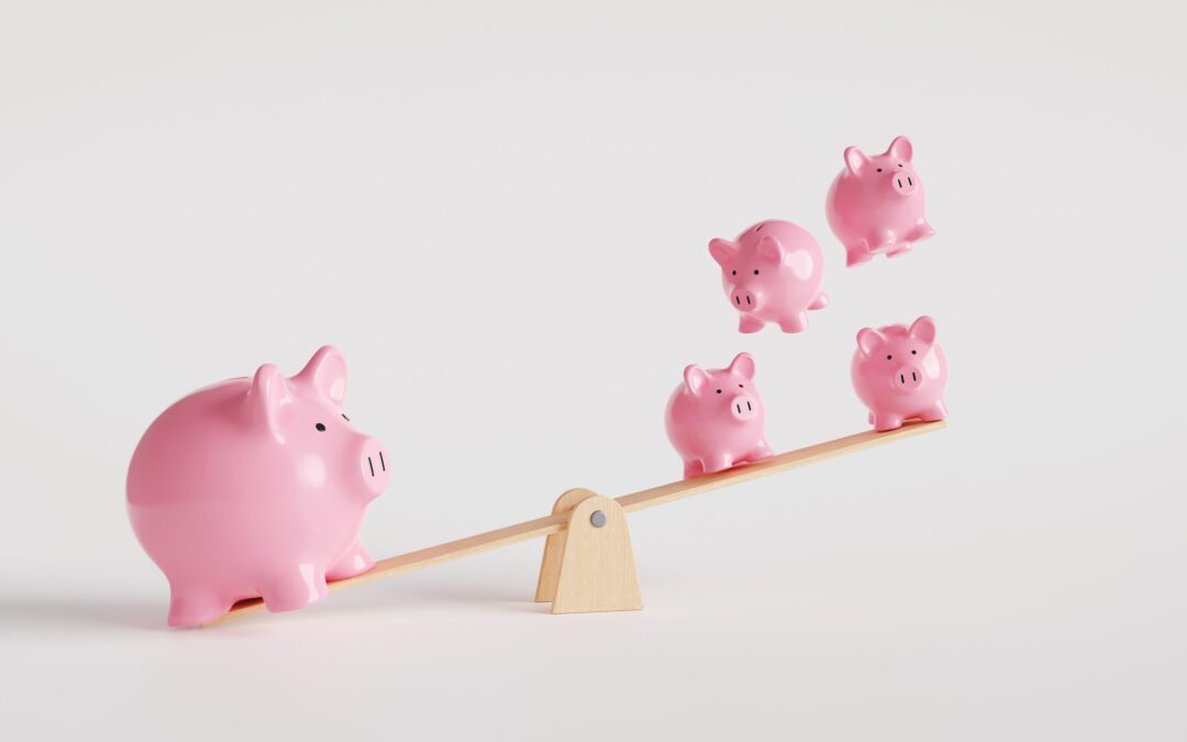 One big pink piggy bank on the left of a seesaw and four smaller money boxes on the other side
